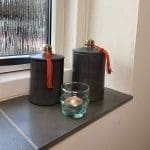Moroccan handmade glass teapots next to stucco jars