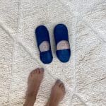 Moroccan handmade slippers in blue with foot model on the side