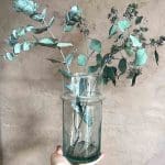 Liten handgjord transparent beldivas med gröna blommor i