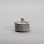 gray round low Moroccan handmade pot in stucco with pink tassel