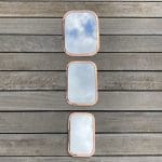 Three rectangular Moroccan handmade mirrors with rounded edges of rose gold metal in different variants