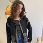 Cardigan/jacket_NOÍR SAUVAGE_in soft black fabric with green trim and snakeskin pockets
