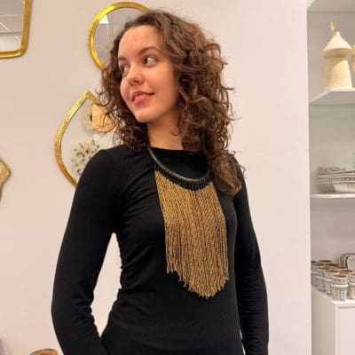 Pearl necklace in gold colors. Black necklace made of braided leather.