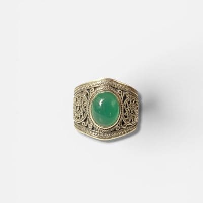 ANIR ring - wide with a greenish turquoise oval-shaped stone in the center and silver carved patterns.