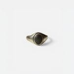 Bague simple en argent avec une pierre noire au centre.