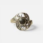 Silver ring with beautiful stone with unique, delicate silver carvings surrounding the black stone in the center.